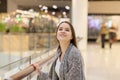 Shopping A young girl looks at shop windows, smiles, makes purchases in a mall Royalty Free Stock Photo