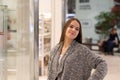 Shopping A young girl looks at shop windows, smiles, makes purchases in a mall Royalty Free Stock Photo