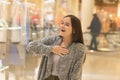 Shopping A young girl in a mall enjoys a sale and discounts