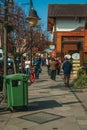 Shops and people walking on sidewalk at Gramado