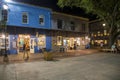 Shops, restaurants and bars inside the City Market at night with with tables and chairs and colorful paintings on the walls Royalty Free Stock Photo