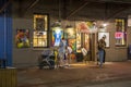 Shops, restaurants and bars inside the City Market at night with with tables and chairs and colorful paintings on the walls Royalty Free Stock Photo