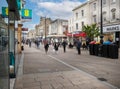 Shops and shoppers in the High Street in Cheltenham Gloucestershire, UK Royalty Free Stock Photo