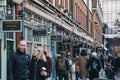 Shops in Spitalfields Market, London, UK, people walking past, selective focus