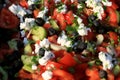 Shopska salad. Prepared from sliced tomatoes, cucumbers, roasted peppers, onion, olives, fresh parsley and grated white brined che