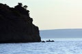 A shore, a boat and a man at hte evening