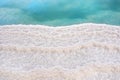 Shore of Dead sea in Ein Bokek, Israel, white salt crystals outside and at the bottom, turquoise clear water Royalty Free Stock Photo