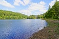 On the shore of Derwent Reservoir with a partially hidden Howden Dam in the distance Royalty Free Stock Photo