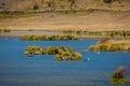 Shore of the lake Limpiopungo located in Cotopaxi national park, Ecuador in a sunny and windy day