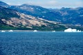 Greenlandic coastline with uninhabitated mountains and icebergs in Arctic Ocean