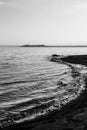 Shore of Trasimeno lake Umbria, Italy with Castiglione del Lago town at the distance