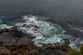 Shore with waves breaking over limestone rocks Royalty Free Stock Photo