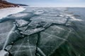 The shore of the winter Lake Baikal with broken ice near the shore and open water Royalty Free Stock Photo