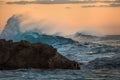 Shorebreak Blue Wave Crest with orange sky at sunset background