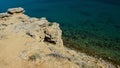 Shoreline arid rock above Sveta Maria beach on Pag Island, Croatia, clear azure blue water.