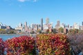 Shoreline of Astoria Queens New York with Red Leaf Plants looking towards the East River and the Manhattan and Roosevelt Island Sk