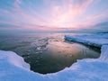 Shoreline of Lake Superior in winter at sunset