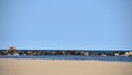 Shoreline with sand, water, rocks and blue sky Royalty Free Stock Photo