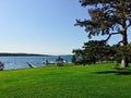 Shoreline of Skaneateles lake with anchored boats, surrounded by green vegetation, New York