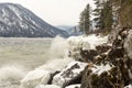 Shoreline of Teletskoye lake with thundering waves, in winter. Russia, Altai territory