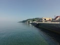 On the shores of the azure Black Sea, holiday homes for tourists. The stairs lead down to the seashore. Beautiful seascape