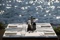 Shoreside table setting with blurred sea Royalty Free Stock Photo