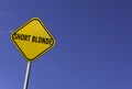 Short blonde - yellow sign with blue sky background