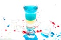 Short blue coctail with ice and color drops