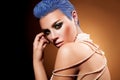 Short blue hairstyle and green makeup of female in studio Royalty Free Stock Photo