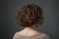 Short Brown Curly Hair , Rear View On Gray Background. Generative AI