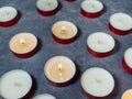 Short candles are burning against a dark background. Lots of small candles. Not all candles are lit Royalty Free Stock Photo