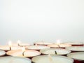 Short candles are burning against a white background. Lots of small candles. Not all candles are lit Royalty Free Stock Photo