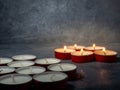 Short candles are burning on a dark background. Lots of small candles. Not all candles are lit Royalty Free Stock Photo