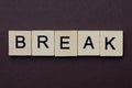 Short gray word break made of wooden square letters