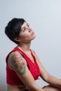 Short-hair brunette woman looking up wearing a red tank top Royalty Free Stock Photo