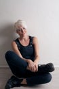 Short-haired blonde sits on the floor in the room Royalty Free Stock Photo