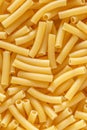 Short Italian pasta penne. Pasta is delicious Italian traditional food made from wheat flour like noodles.Dry pasta background.Top Royalty Free Stock Photo