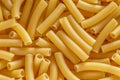 Short Italian pasta penne. Pasta is delicious Italian traditional food made from wheat flour like noodles.Dry pasta background.Top Royalty Free Stock Photo