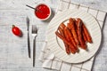 Short italian pork sausages chipolata with ketchup