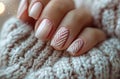 short nails with white and pink nail polish, winter themed, in a knitted sweater, closeup photo, soft light, pastel Royalty Free Stock Photo