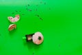 A short pencil stuck in a sharpener after longing, cleaning from a pencil on a green background Royalty Free Stock Photo