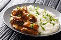 Short ribs cooked in a spicy sauce with rice garnish close-up on a plate. horizontal Royalty Free Stock Photo