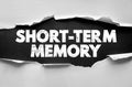 SHORT-TERM MEMORY text shown through ripped paper background. Distressed bold font highlights cognitive function, brain, Royalty Free Stock Photo