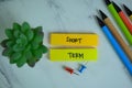 Short Term write on sticky notes isolated on Wooden Table