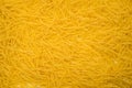 Short thin vermicelli on the whole background. texture of dry yellow pasta Royalty Free Stock Photo