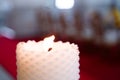 Short white candle on bokeh light background Royalty Free Stock Photo