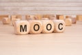 short word english text MOOC on a wooden cubes with wooden background