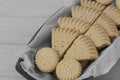 Shortbread biscuits cookies on greaseproof paper in a wooden bowl. Royalty Free Stock Photo