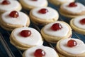 Shortbread biscuits with white icing and a cherry