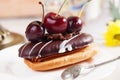 Shortbread cake with chocolate eclair a cherry Royalty Free Stock Photo
